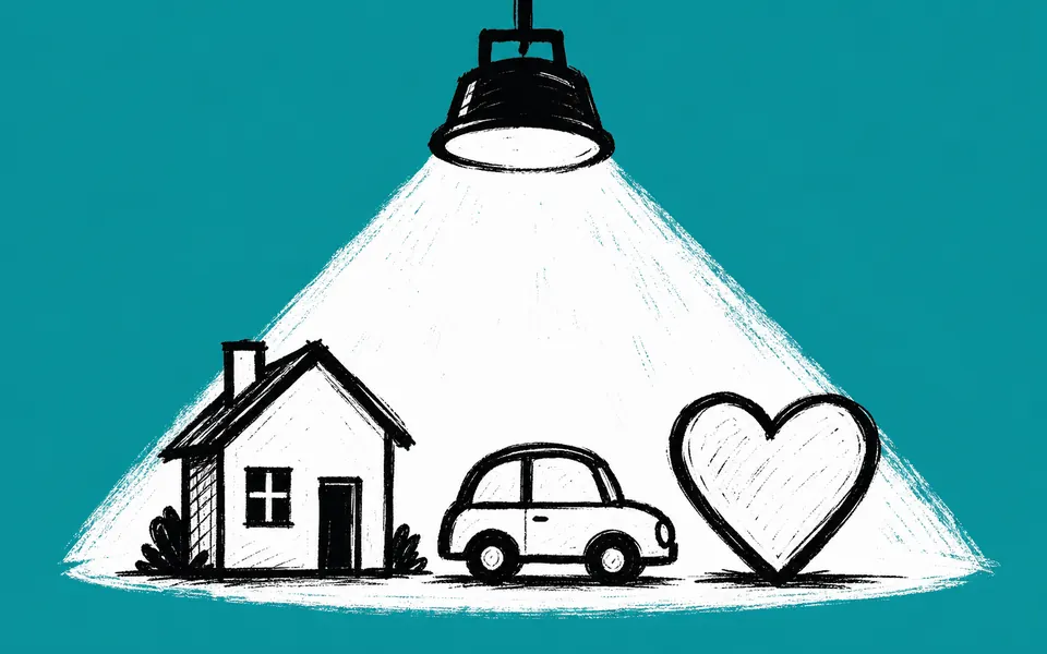 A drawing of a house, a car and a heart under a spotlight